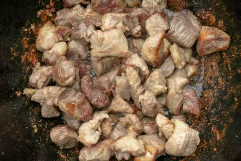 Step-by-step process of cooking pilaf in a cast iron cauldron Stock-Fotos