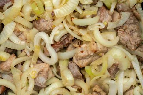 Step-by-step process of cooking pilaf in a cast iron cauldron Stock Photos