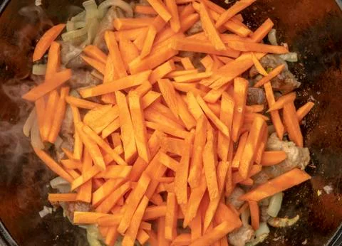 Step-by-step process of cooking pilaf in a cast iron cauldron Stock Photos
