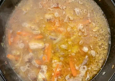 Step-by-step process of cooking pilaf in a cast iron cauldron Stock Photos