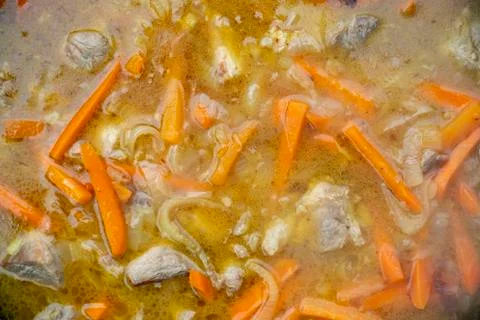 Step-by-step process of cooking pilaf in a cast iron cauldron Stock Photos