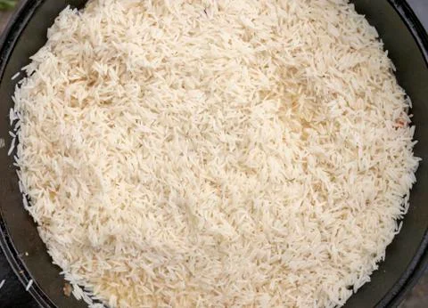 Step-by-step process of cooking pilaf in a cast iron cauldron Stock Photos