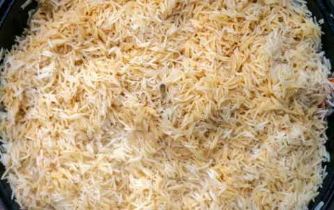 Step-by-step process of cooking pilaf in a cast iron cauldron Stock Photos