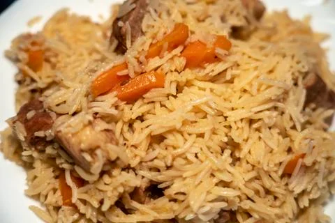 Step-by-step process of cooking pilaf in a cast iron cauldron Stock Photos