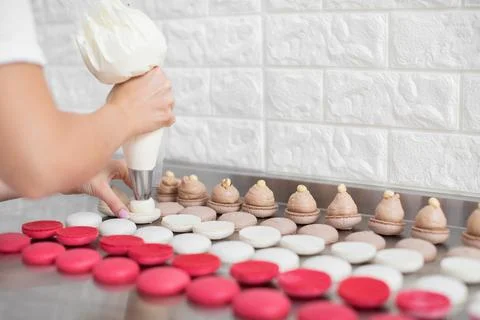 Step by step process of making macarons in confectionery shop. Close up Stock Photos