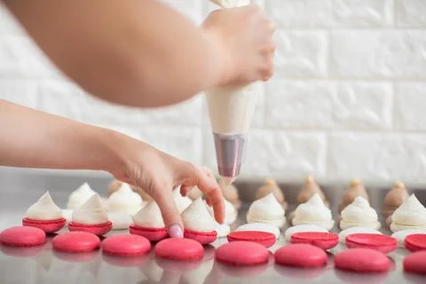 Step by step process of making macarons in confectionery shop. Close up Stock Photos