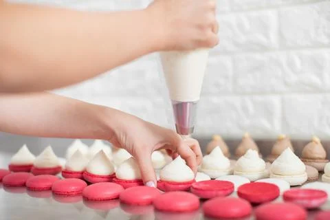 Step by step process of making macarons in confectionery shop. Close up Stock Photos