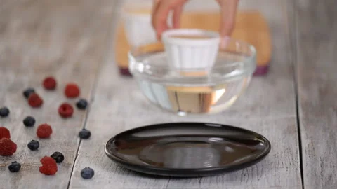 Step By Step Process Of Making A Modern Berry Mousse Dessert. Dipping the molds Stock Footage 124735756