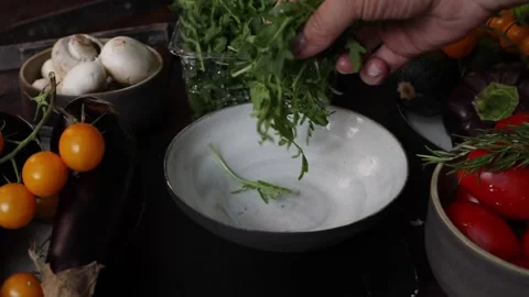 Step-by-step process for making tomato and cheese salad in a ceramic bowl Stock Footage 280383124
