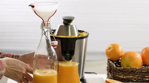  Step by step process squeezing oranges using electric juicer.  Stock Footage 125543014