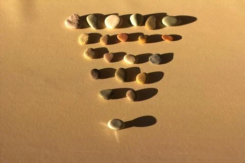 Step by Step Progress Concept with Pebbles and Strong Shadows on Warm Backgr Stock Photos