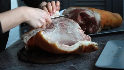 Step-by-step recipe for pork knuckle roll, female cook separates skin from pork Stock Footage 126108614