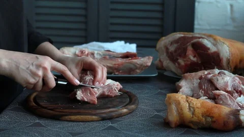 Step-by-step recipe for pork knuckle roll, female cook cuts meat Stock Footage 126768241