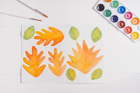 Step-by-step tutorial autumn wreath. Step 1: Paint autumn leaves different sh Stock Photos