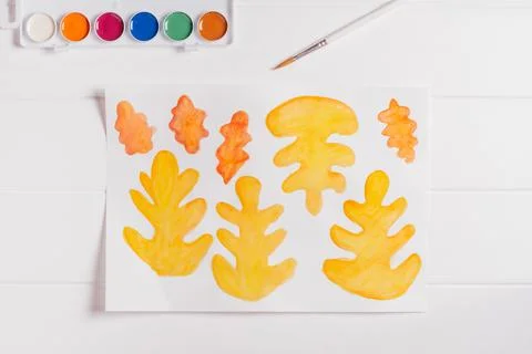Step-by-step tutorial autumn wreath. Step 1: Paint autumn leaves different sh Stock Photos