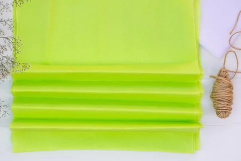 Step by step tutorial on making a light green fluffy pom-pom from tissue pape Stock Photos