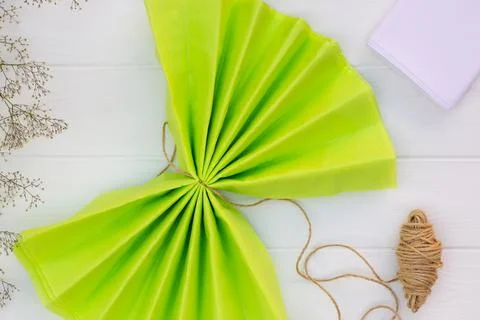 Step by step tutorial on making a light green fluffy pom-pom from tissue pape Stock Photos