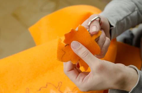 Step by step a woman cuts maple leaves from felt Stock Photos