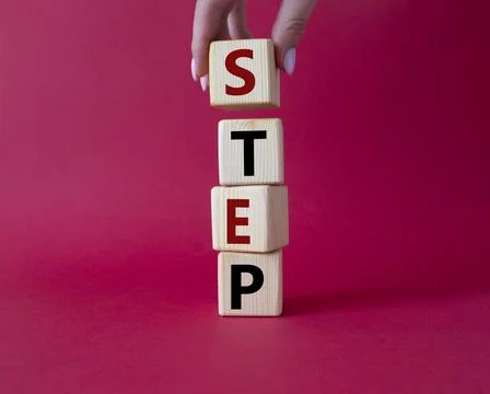 Step symbol. Concept word Step on wooden cubes. Businessman hand. Beautiful.. Stock Photos