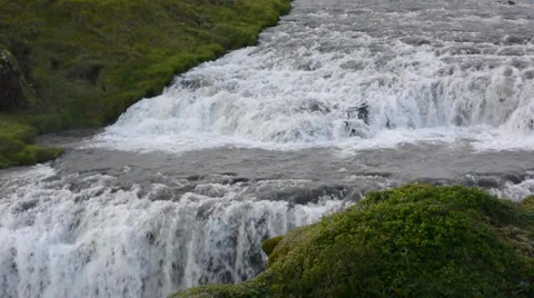 Step waterfall and a rock above bigger Skogafoss waterfall, Iceland Stock Footage 33747652