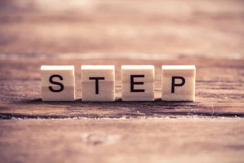 Step word of wooden elements with letters Stockfoto's