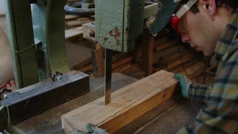 Step into the world of a farmer's workshop, where a plaid-shirted artisan Stock Footage 258649332