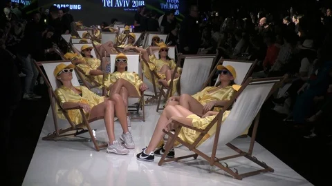 Stephane Legar and Bananhot present sun bathing models, beach chairs runway Stock Footage 87695098