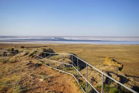 In the steppe clouds float across the sky, and on the ground there is a salt Stock Photos