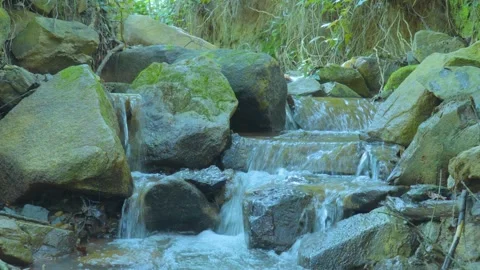 Stepped Waterfall Through Mossy Rocks: Nature's Tranquil Cascade Stock Footage 281558202
