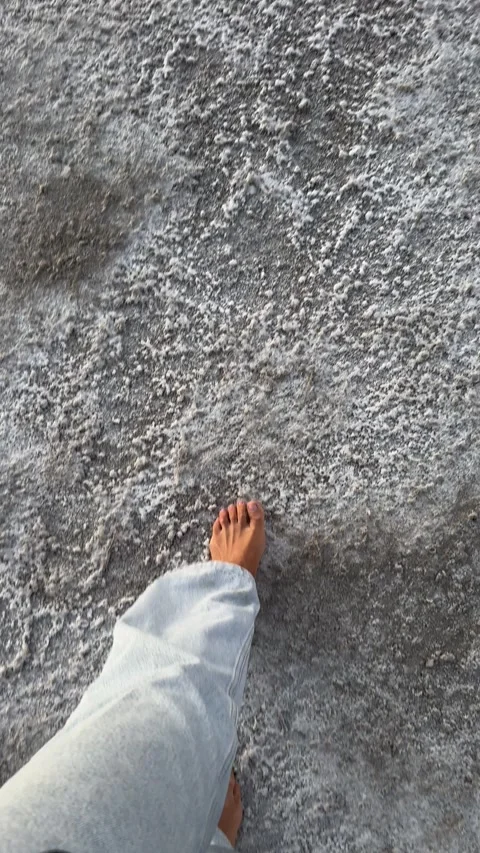 Stepping on Cracked Earth in a Dry Salt Flat Stock-Footage 342607328