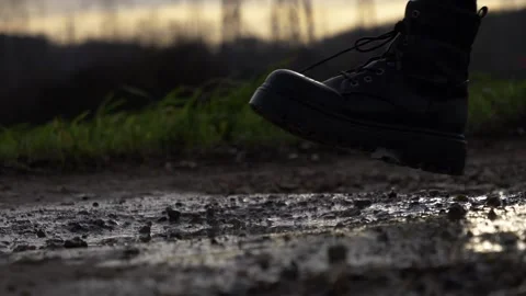 Stepping into puddle and splashing dirty water Stock Footage 157007543