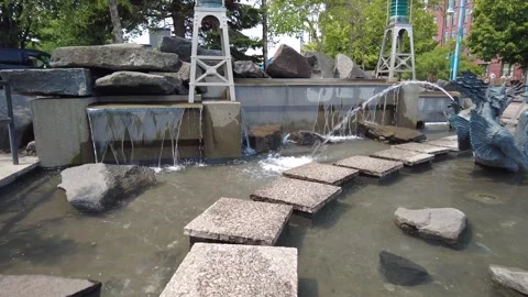 A stepping-stone path through an aquatic park Stock Footage 247136430