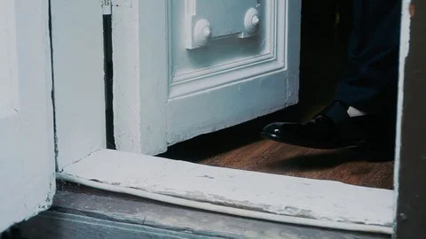 Stepping through the threshold of a house Stock Footage 119306845