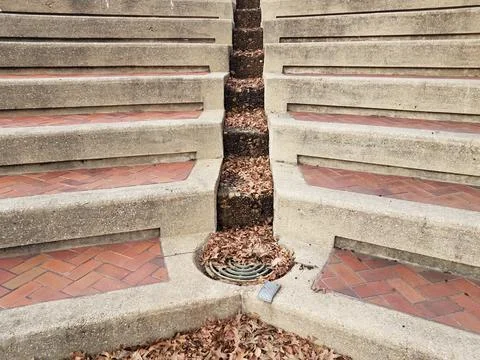 Steps and bricks and drain with fallen leaves Stock Photos
