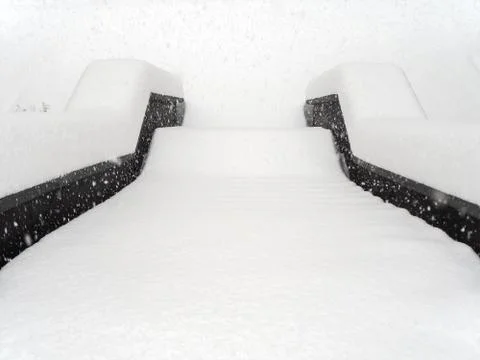 The steps are strewn with an even layer of snow on a foggy day during heavy Stock Photos