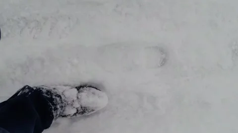 Steps in boots on snow-covered ice top view Stock Footage 46370790
