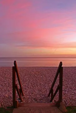 Steps at budliegh beach at sunset Stock Photos