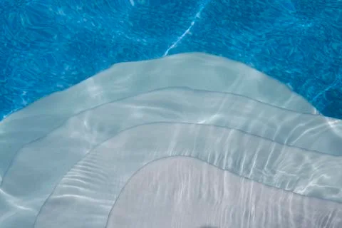 Steps into cool blue pool Stock Photos