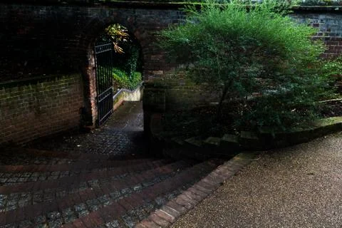 Steps down to an arched door way outside Stock Photos