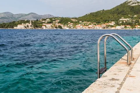 Steps down to the blue water Stock Photos