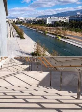Steps down, crossed by shadows, on a sunny day at the Stavros Niarchos Center Stock Photos