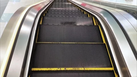 The steps of an empty escalator move up close up view from above 動画素材 267795905
