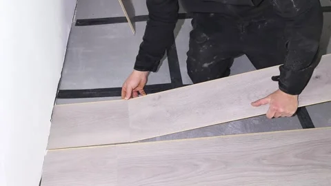 Steps to install laminate flooring in a room with a simple approach and clear me Stock Footage 326374958