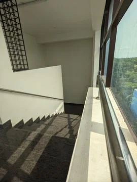 Steps interior in the building with Sun rays Stock Photos