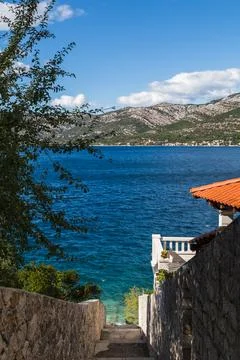 Steps lead down to the aqua colours of the Peljesac channel Stock Photos
