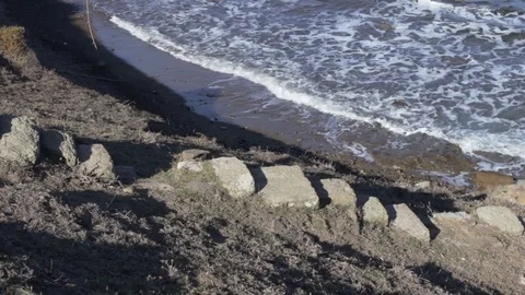 Steps leading down to ancient archaeological remains of harbor. Stock Footage 82260843