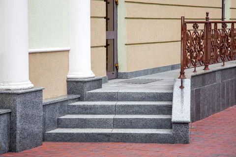Steps leading up to a threshold building of granite stairs. Stock Photos