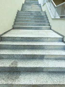 Steps leading upward in a building with a solid surface and marked safety a.. Stock Photos