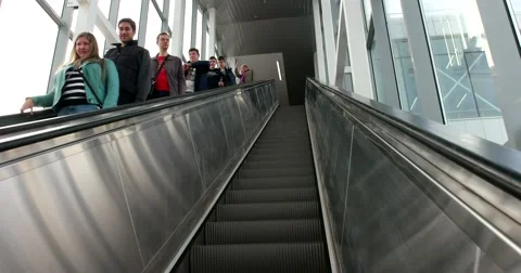Steps of a moving escalator, going down people Stock Footage 67470374