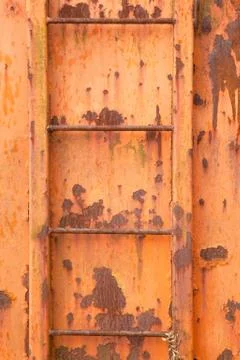 Steps of old orange and rusty container on vertical image Stock Photos